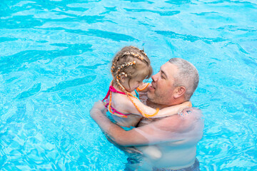 dad and little dod spend the weekend at the swimming pool