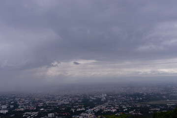 The view from the top of the mountain to see the beautiful scenery of Chiang Mai during the rainy season makes it possible to see the rain cloud and rain that are falling towards Chiang Mai city.