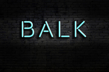 Night view of neon sign on brick wall with inscription balk