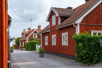typical red Swedish wooden houses line the streets of the historic city center of downtown Trosa