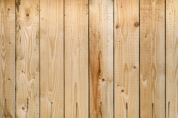 Light wood wall texture.
Natural wood background.
Old wooden fence made of vertical planks in a rural area.