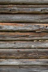 Dark wooden wall texture.
Natural wood background.
Old wooden wall of a house made of horizontal planks in the countryside.