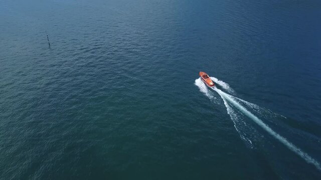 Motorboat moves in Como lake, aerial view from the drone