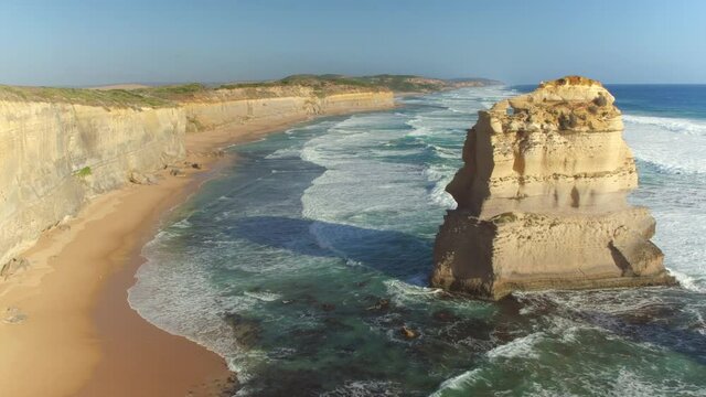 DRONE: Stunning view of the rugged empty shoreline of 12 Apostles in remote part of Australia. Flying along the famous rugged Australian coast with towering cliffs and massive limestone stacks..