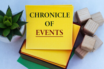 CHRONICLE OF EVENTS - words on a yellow note paper on a light background with a cactus