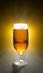Beer glass isolated on a bright yellow background. 
