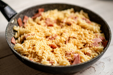 Pasta with bacon and cheese with a creamy sauce.