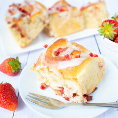 Vanilla yeast rolls with strawberries and frosting. Homemade yeast buns.