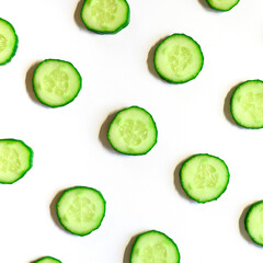 repeating pattern of sliced semicircles of fresh raw vegetable cucumbers for salad isolated on a white background flat lay, top view. square