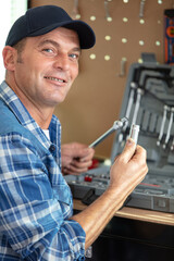 handyman sitting and holding toolbox