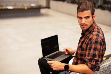 Man shopping online with laptop. Young man buying online with credit card