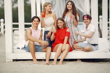 Fototapeta premium Friends have fun on a beach with drinks