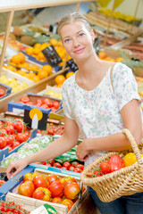 Filling her basket up with vegetables