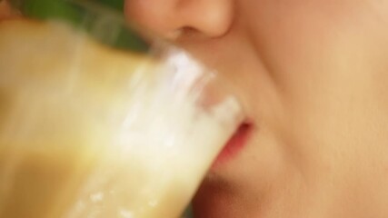 Slow motion footage of a female person drinking coffee latte from a glass. Lifestyle woman enjoying energetic caffeine drink at home. Relishing hot beverage in a restaurant close up. Breakfast cup.