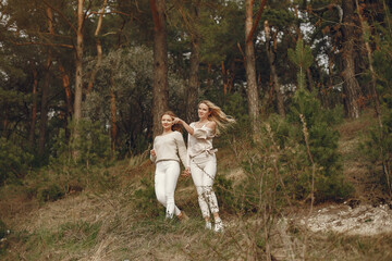 Fototapeta premium Elegant mother with daughter in a summer forest