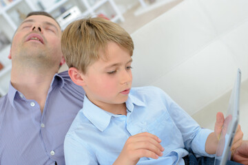 a young boy playing tablet