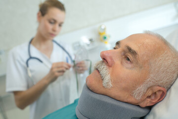 Fototapeta premium doctor with patient wearing neck brace