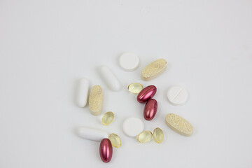 Different types of vitamins and pills on a white background. Can be used as a background. Copy space.