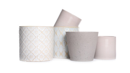 Different stylish ceramic flowerpots on white background
