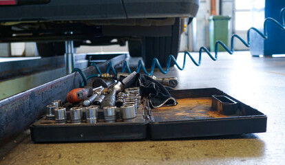 tools lying in a chaotic order in the car repair shop