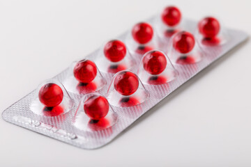 red round tablets of vitamin E in a blister close-up