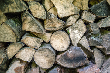 Fototapeta premium A pile of firewood. Preparation of firewood for the winter. Firewood background