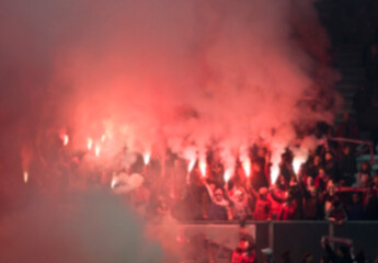 Blurred image of soccer supporters with torches