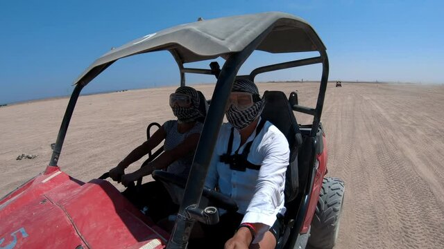 Quad bike buggy ride through the desert near Sharm el Sheikh, Egypt.Adventures of desert off-road on ATV.Sand and Sand Borkhan. Rock and sunset. Quad Cycle Travel. Excursion with people.