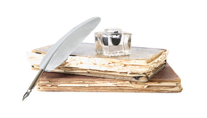 Feather pen, inkwell and old books on white background