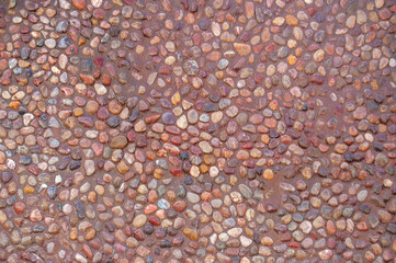 Transparent water flows down the pebbles. Pebble or gravel background or texture.