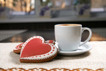 Enjoyable breakfast. Closeup shot of a cup of warm beverage and heart shaped cookies with discount percentage written on