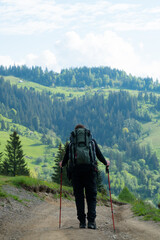 Fototapeta na wymiar hiker walking mountain path in summer