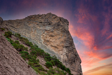 The mountain at sunset. A rock under the evening rays of the sun.