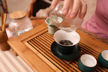Master conducting traditional tea ceremony at table, closeup