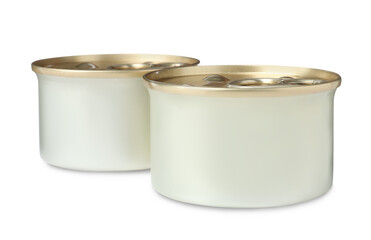 Tin cans of wet pet food on white background