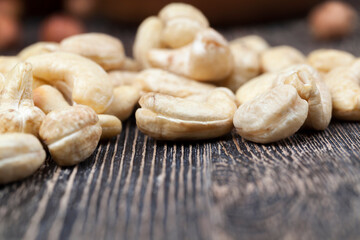 cashew nuts on an old wooden table, close up