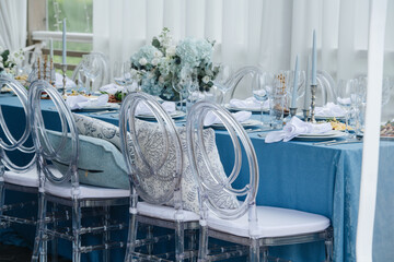 Beautiful dinner setting, long table set for an event on a terrace.