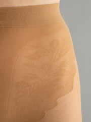 close-up of the belt of beige tights - obrazy, fototapety, plakaty