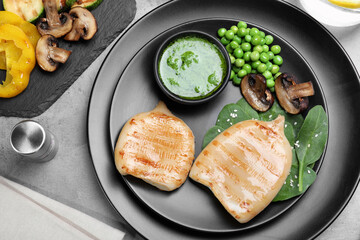 Grilled squid tubes served on grey table, flat lay