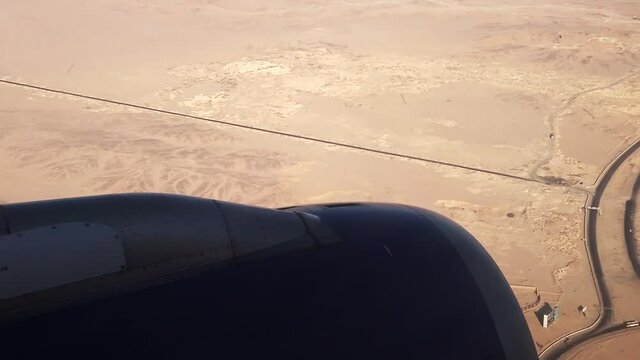 Plane Flying Over Desert Terrain Landing On Airport In Hurghada, Egypt