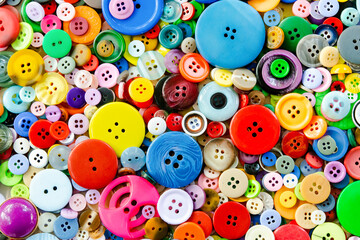 Fototapeta na wymiar Colorful mixed sewing buttons background. Top view