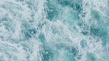 3D rendering of a top view of turquoise waves with foam. Water splash in the sea, ocean on a bright sunny day