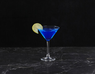 Curacao cocktail on black background