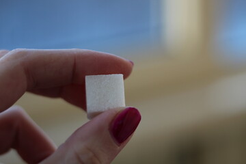 isolated hand holding a sugar cubes sweet 