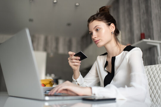 Female with credit card using laptop