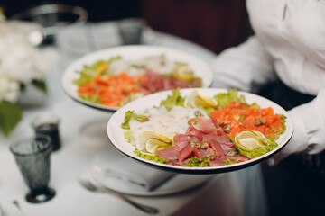 Various cold cuts on a plate waiter catering holds