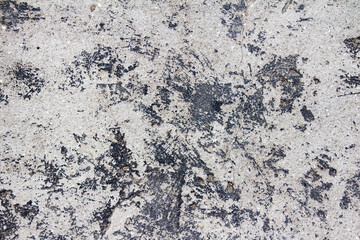 Texture photo of grey colored concrete wall with balck grungy paint.