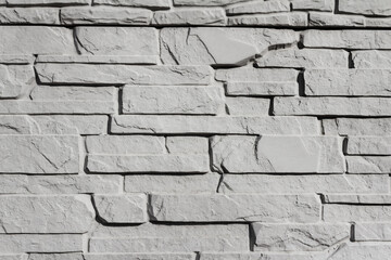 Grey colored photo texture of tile shaped stone concrete wall.