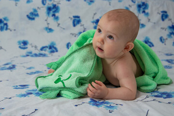 A small child wrapped in a towel after a shower