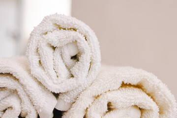 rolled towels. Spa salon interior details. White textiles. Restroom. After washing. Close-up macro. Bathroom . texture soft fabrics